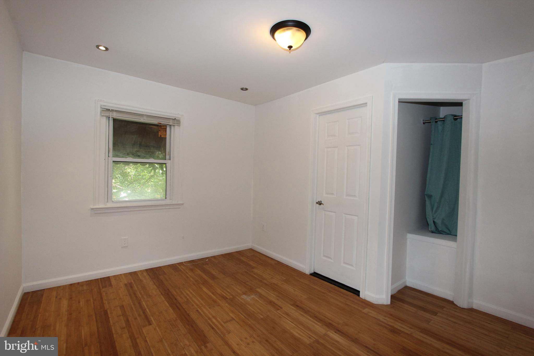 1535 K Street Southeast Washington, DC 20003 - Photo 10 of 21 an empty room with wooden floor and windows
