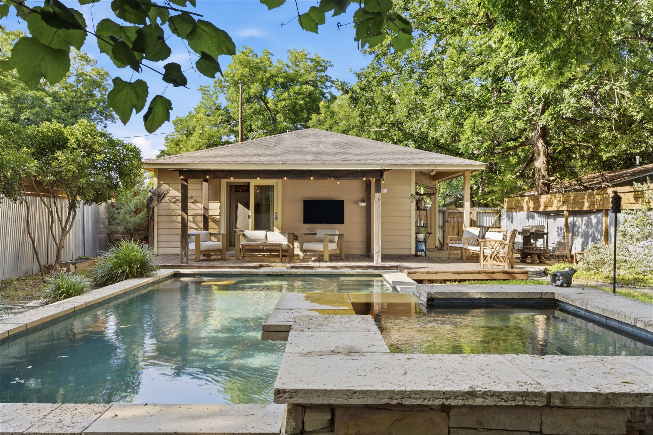 3015 Castro Street Austin, TX 78702 - Photo 37 of 40 An inviting backyard oasis featuring a clear pool with a sun shelf and a cozy deck.