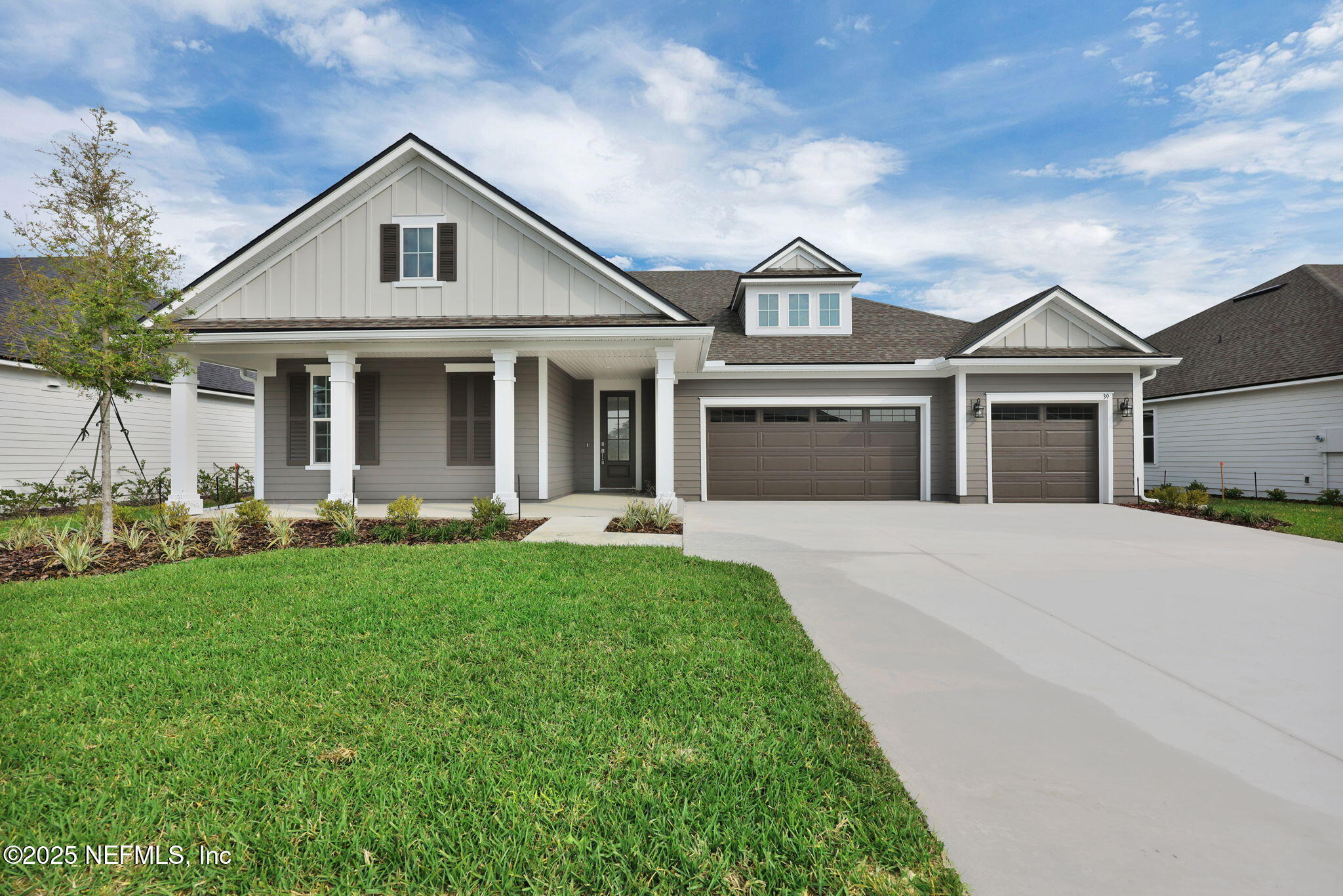 a front view of a house with a yard and porch