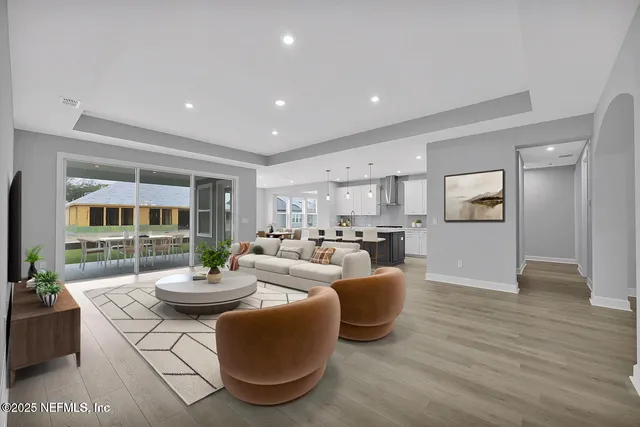 a living room with fireplace furniture and a wooden floor