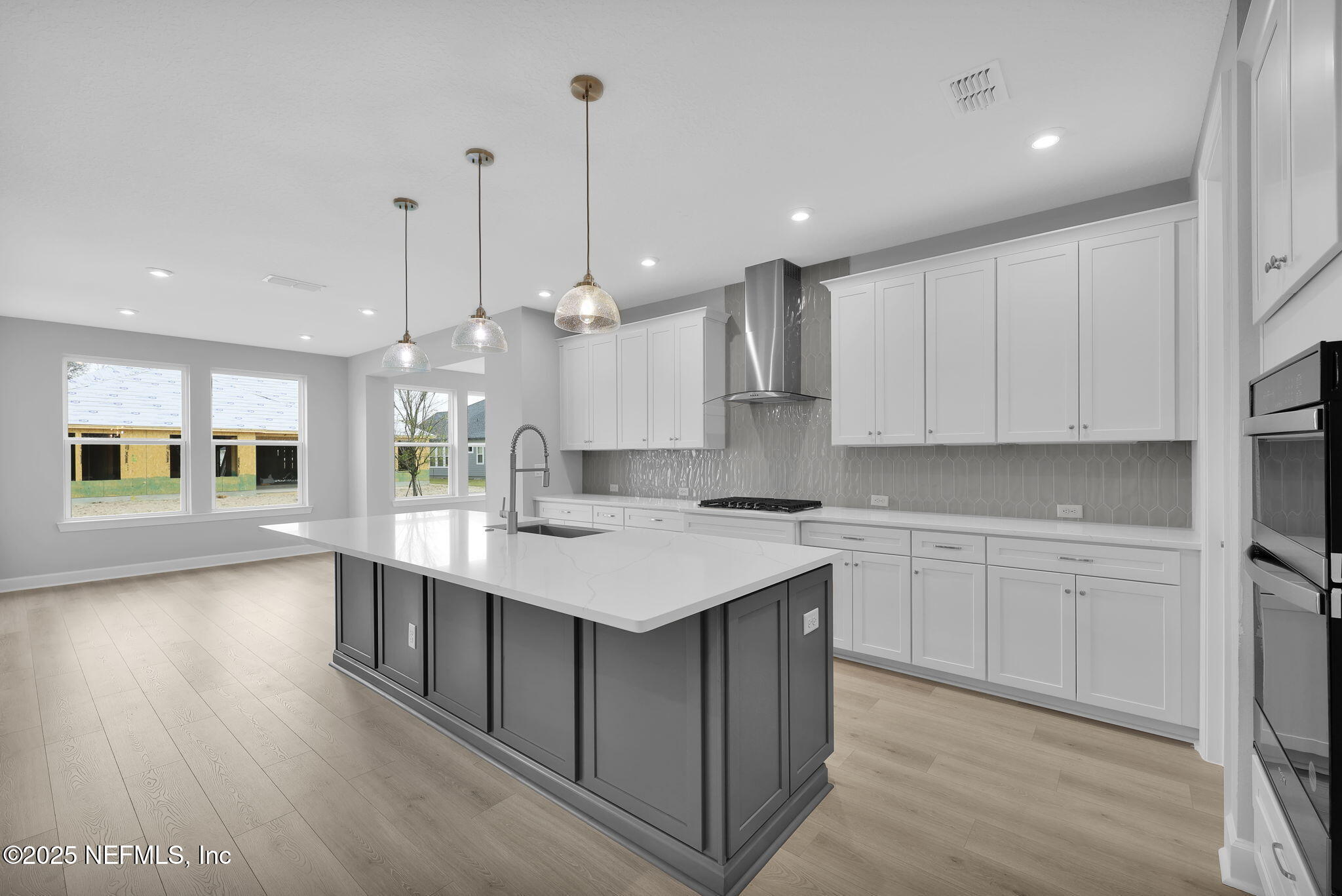 39 Greylock Lane St. Augustine, FL 32092 - Photo 24 of 54 a kitchen with a sink a center island cabinets and a wooden floor