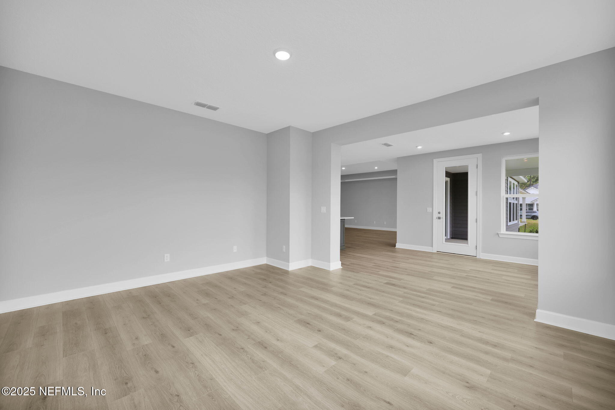 39 Greylock Lane St. Augustine, FL 32092 - Photo 28 of 54 a view of an empty room with wooden floor and kitchen