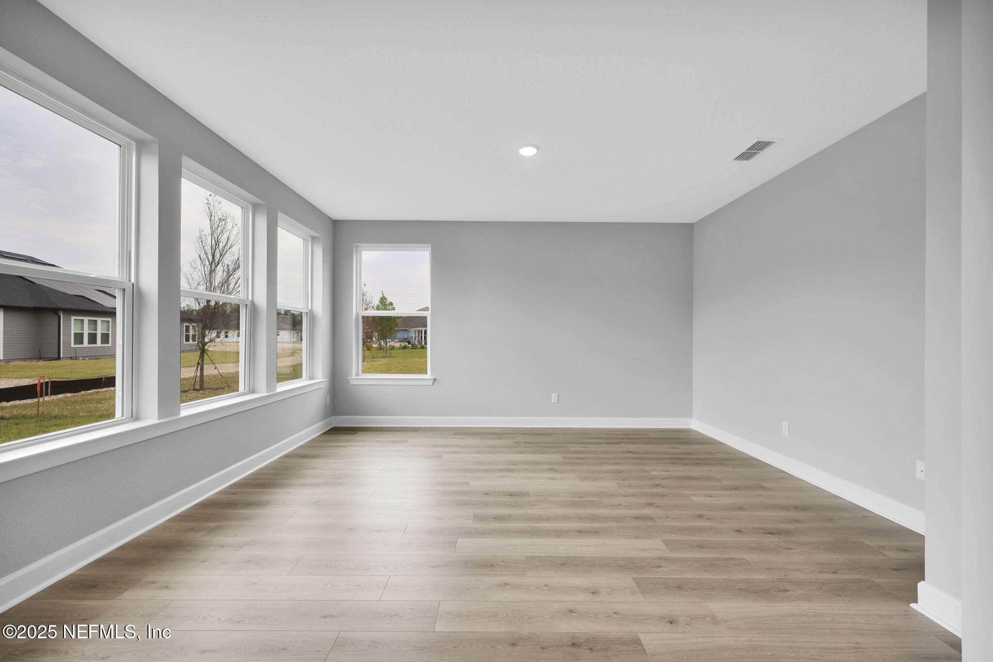 39 Greylock Lane St. Augustine, FL 32092 - Photo 30 of 54 a view of an empty room with a window and wooden floor