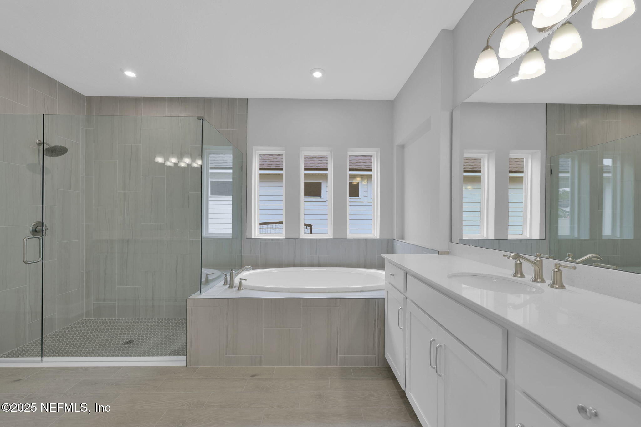 39 Greylock Lane St. Augustine, FL 32092 - Photo 41 of 54 a bathroom with a sink a large mirror and shower