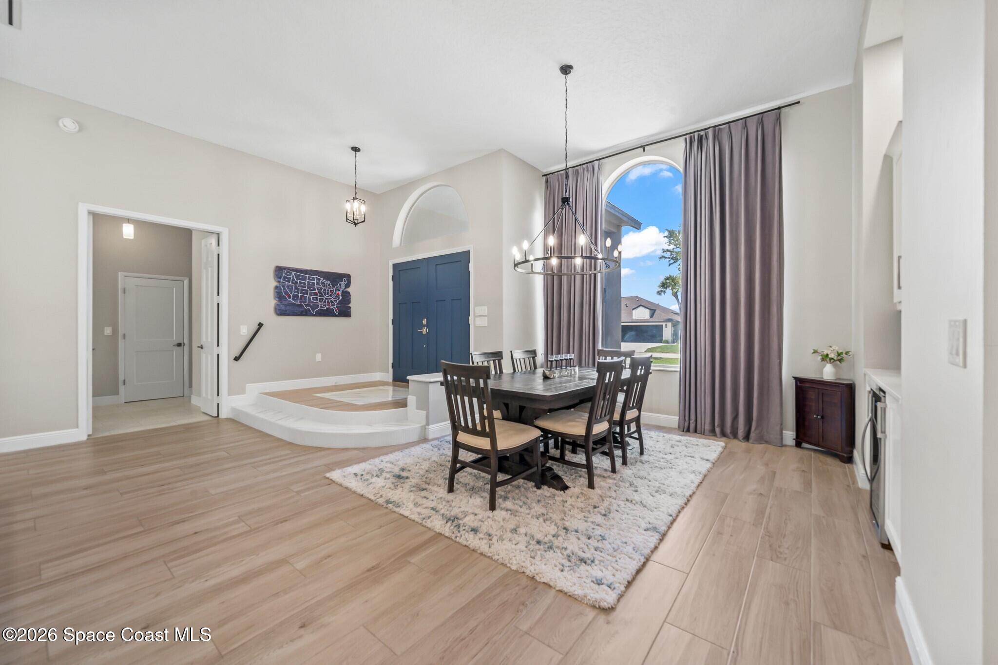 697 Spring Lake Drive Melbourne, FL 32940 - Photo 8 of 45 a view of a dining room with furniture window and wooden floor
