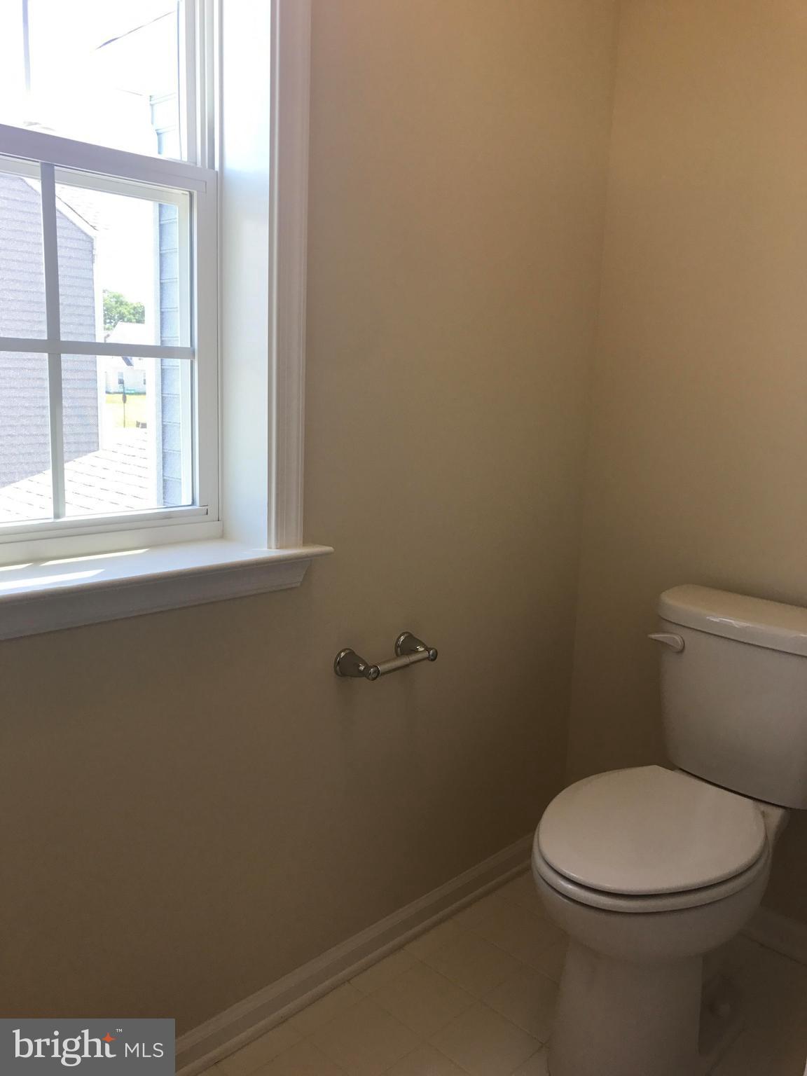 55 Blakely Road Kearneysville, WV 25430 - Photo 12 of 15 a white toilet sitting next to a window