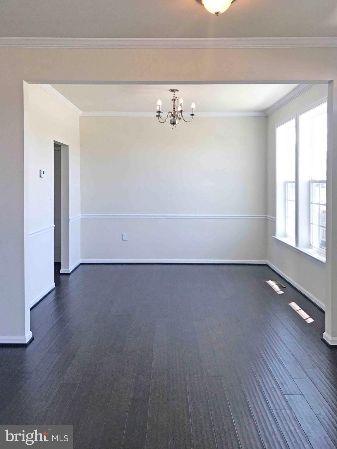 55 Blakely Road Kearneysville, WV 25430 - Photo 4 of 15 an empty room with wooden floor and windows