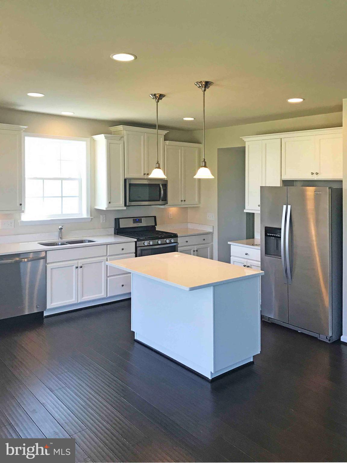 55 Blakely Road Kearneysville, WV 25430 - Photo 5 of 15 a large kitchen with kitchen island a large counter top a sink stainless steel appliances and cabinets