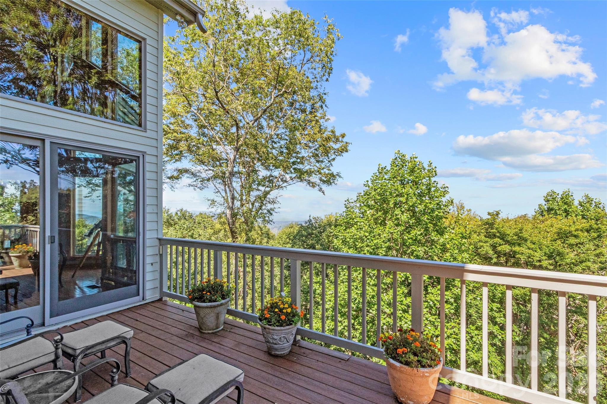 350 Ball Camp Road Burnsville, NC 28714 - Photo 16 of 44 a view of a two chairs on the deck