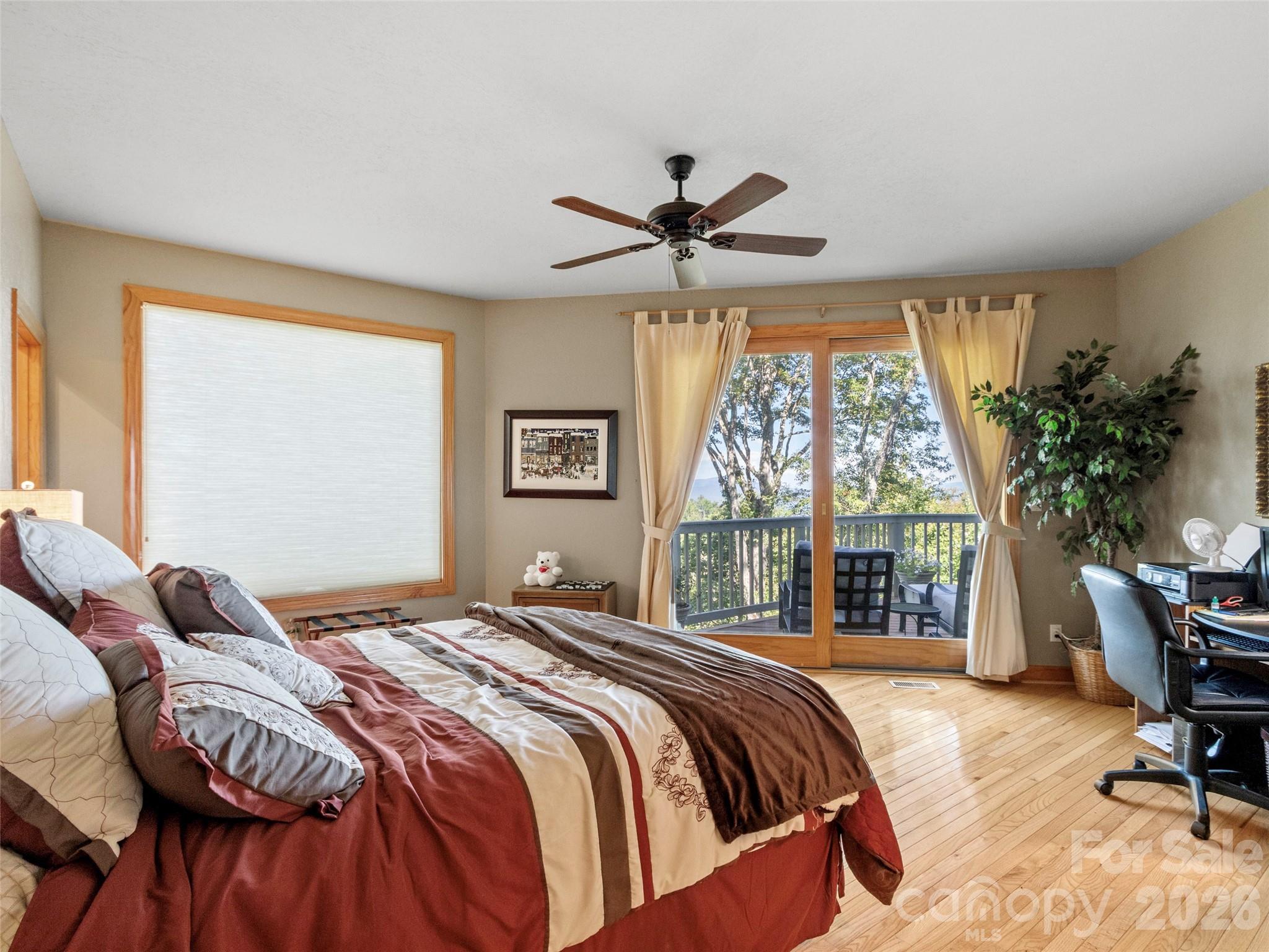 350 Ball Camp Road Burnsville, NC 28714 - Photo 17 of 44 a bedroom with a bed and a large window