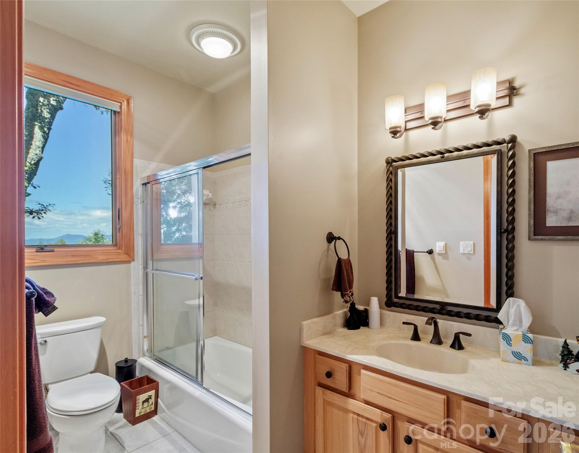 350 Ball Camp Road Burnsville, NC 28714 - Photo 20 of 44 a bathroom with a granite countertop sink mirror and toilet