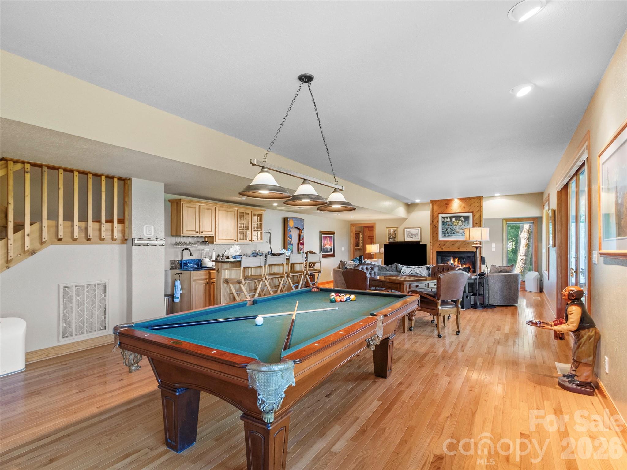350 Ball Camp Road Burnsville, NC 28714 - Photo 22 of 44 a living room with furniture a pool table and a fireplace