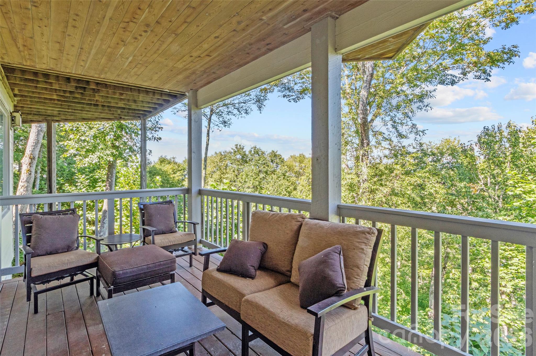 350 Ball Camp Road Burnsville, NC 28714 - Photo 24 of 44 a balcony with furniture and wooden floor