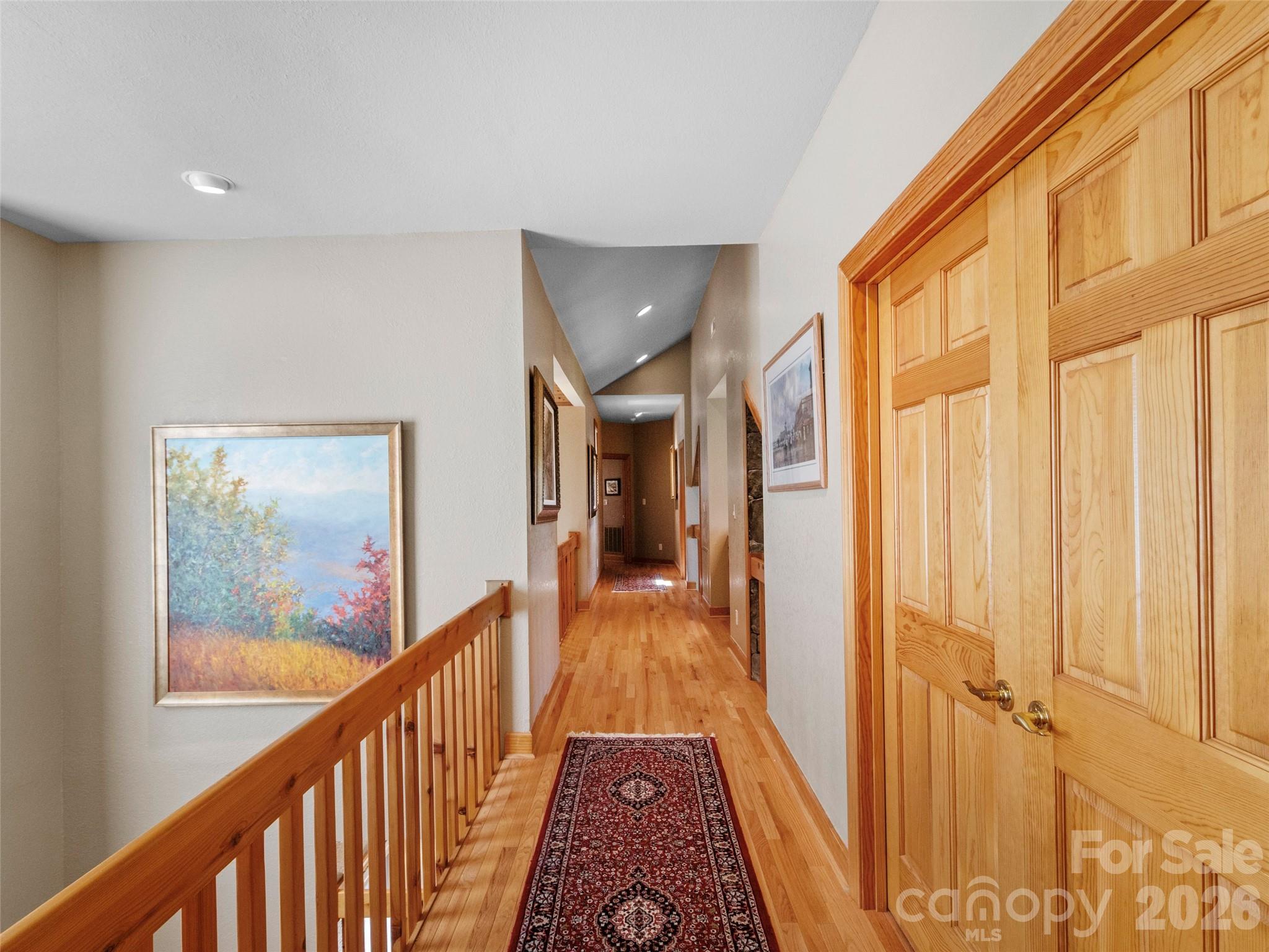 350 Ball Camp Road Burnsville, NC 28714 - Photo 30 of 44 a view of a hallway with wooden floor and staircase