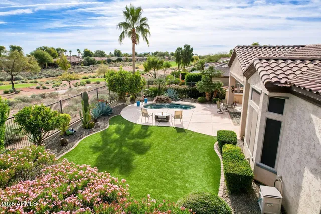 a view of a backyard with plants and patio
