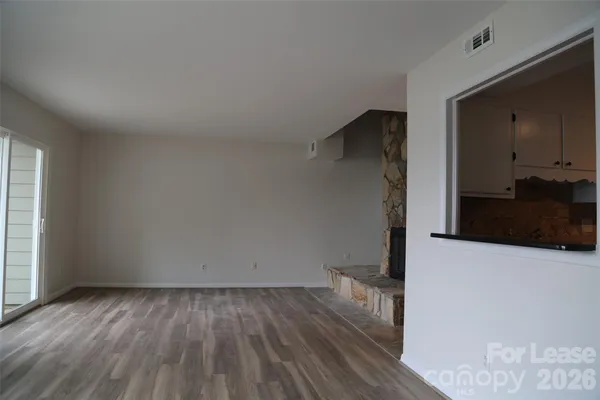 a view of hallway with wooden floor