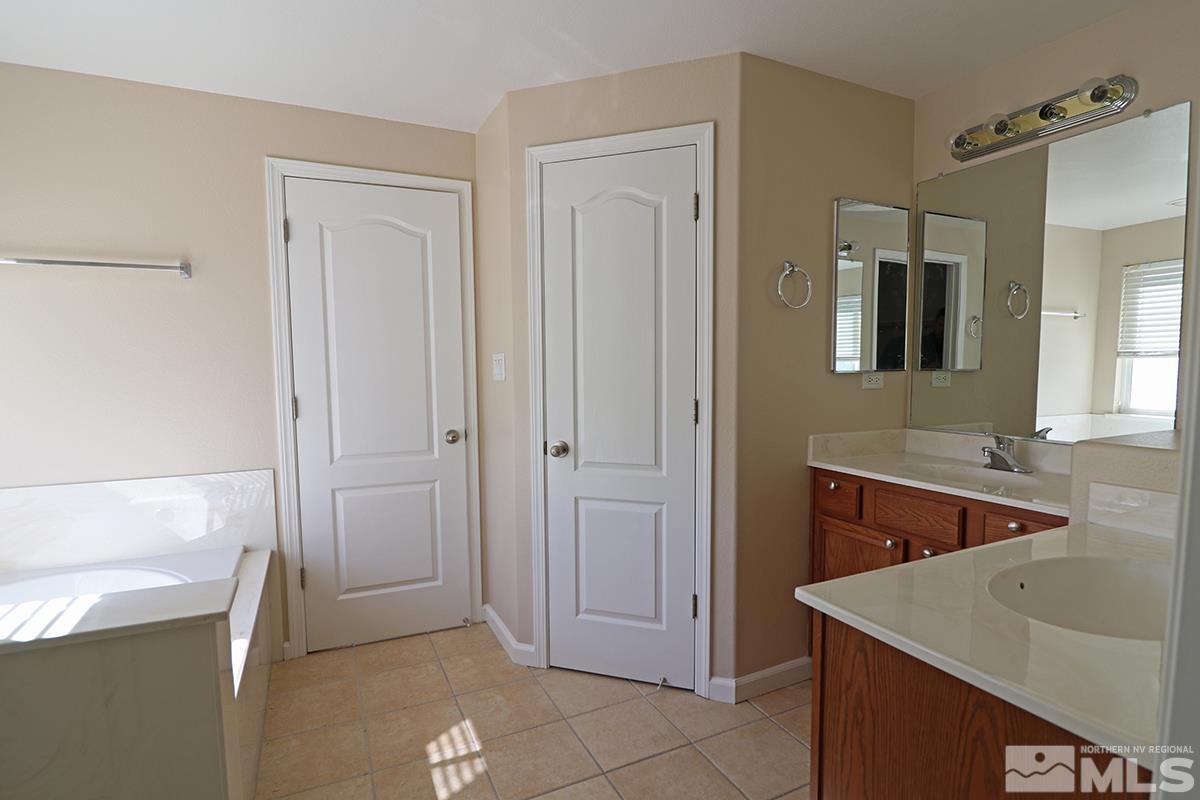 10047 Silver Star Drive Reno, NV 89521 - Photo 16 of 26 a bathroom with a sink a toilet and mirror