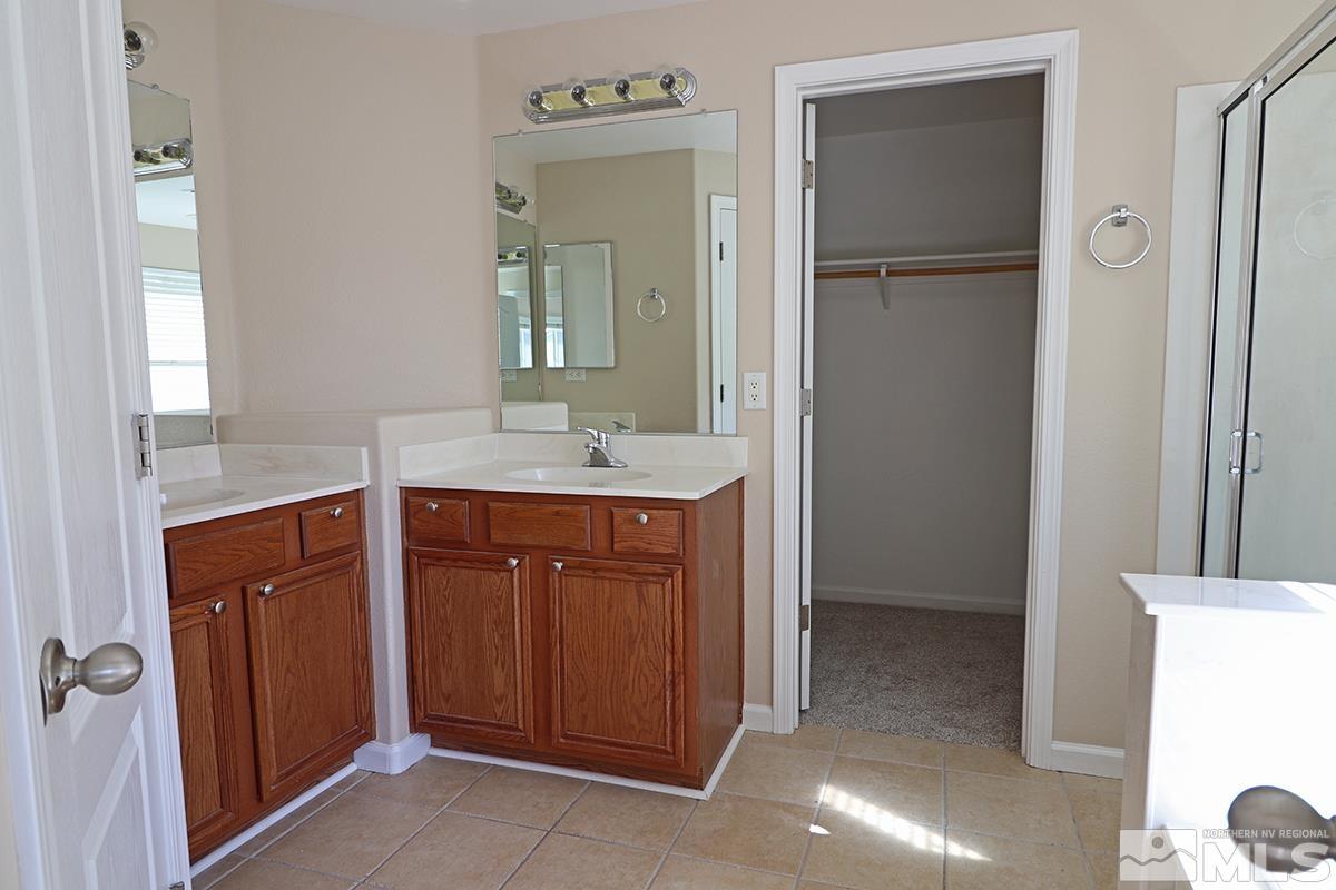 10047 Silver Star Drive Reno, NV 89521 - Photo 17 of 26 a bathroom with a sink and a mirror
