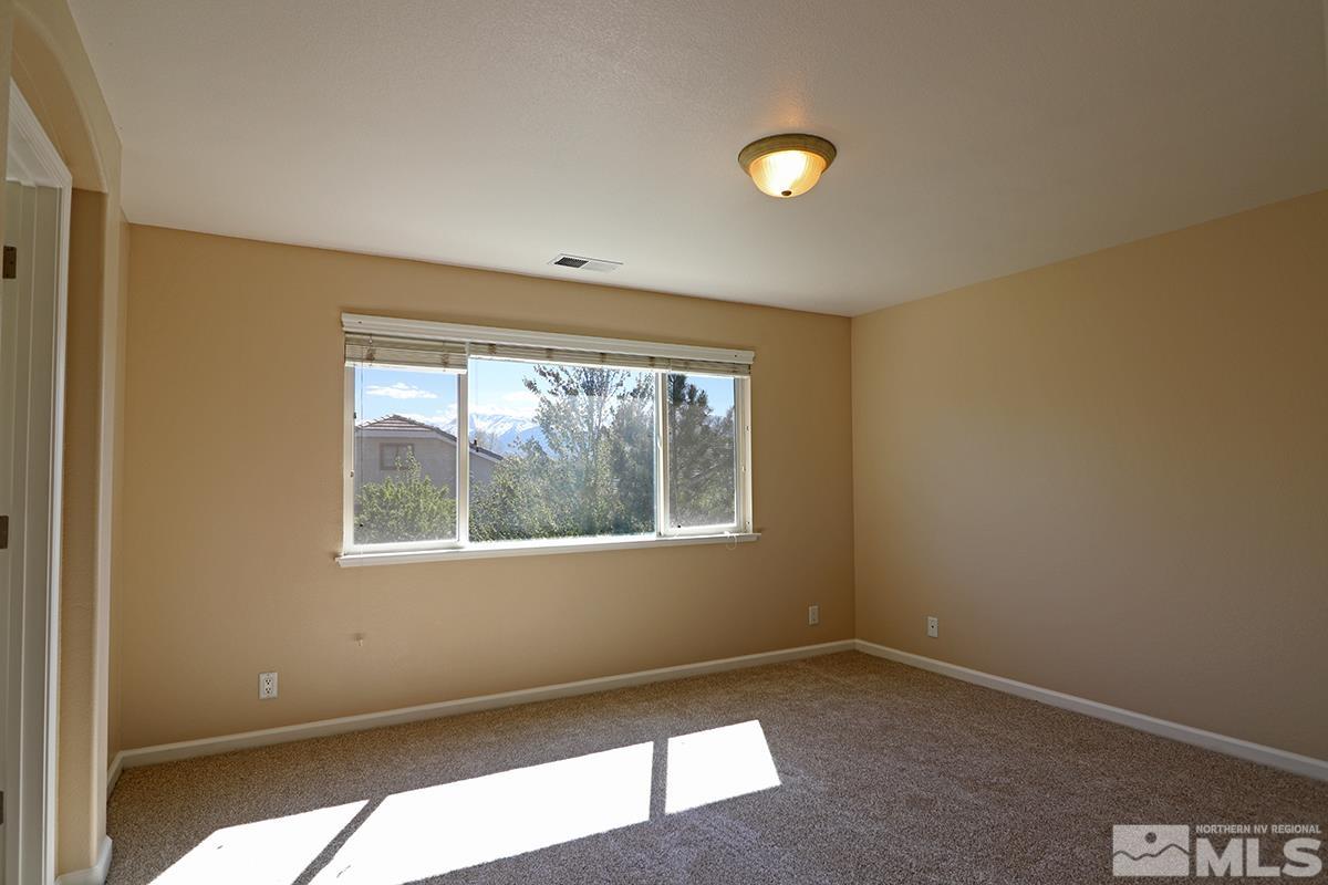 10047 Silver Star Drive Reno, NV 89521 - Photo 22 of 26 a view of an empty room with a window