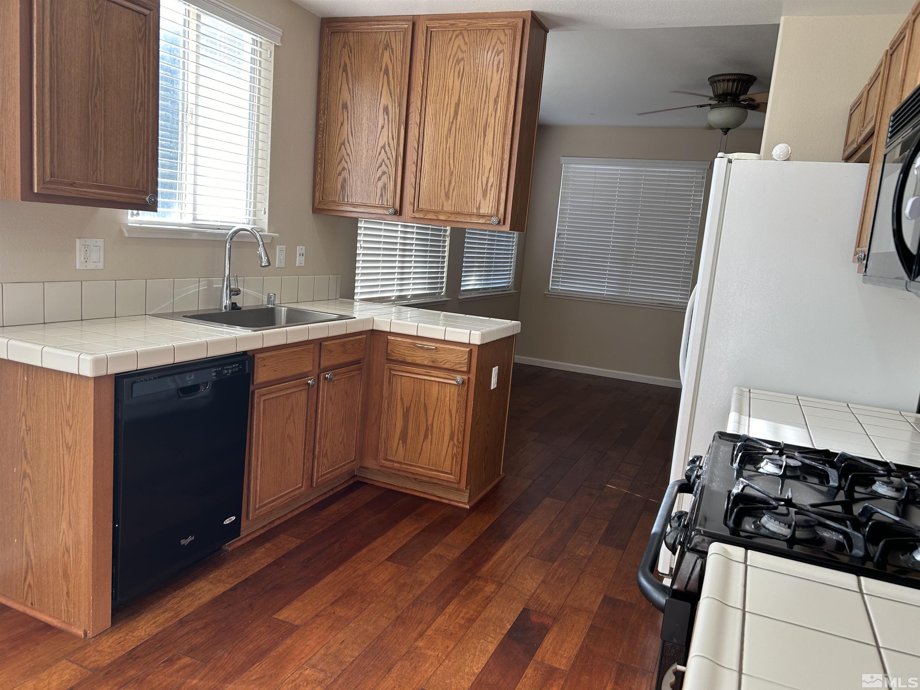10047 Silver Star Drive Reno, NV 89521 - Photo 26 of 26 a kitchen with stainless steel appliances a sink stove and cabinets
