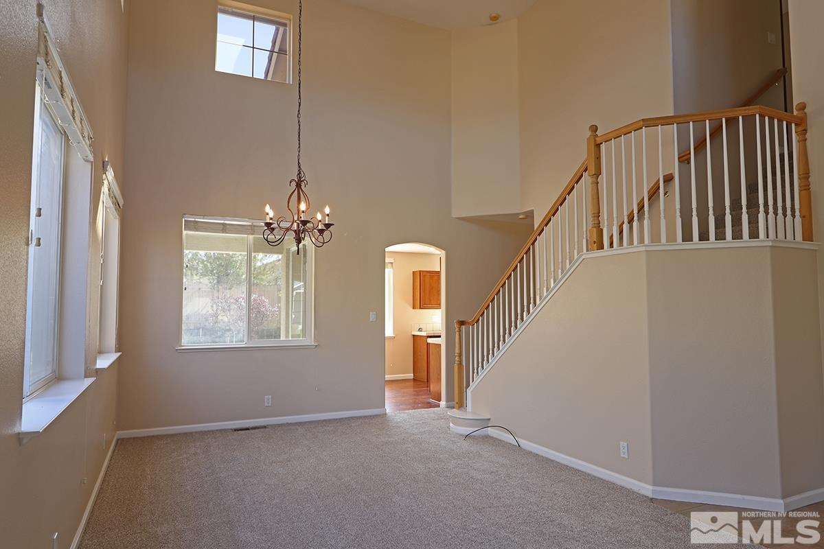 10047 Silver Star Drive Reno, NV 89521 - Photo 3 of 26 a view of an entryway with wooden floor and windows