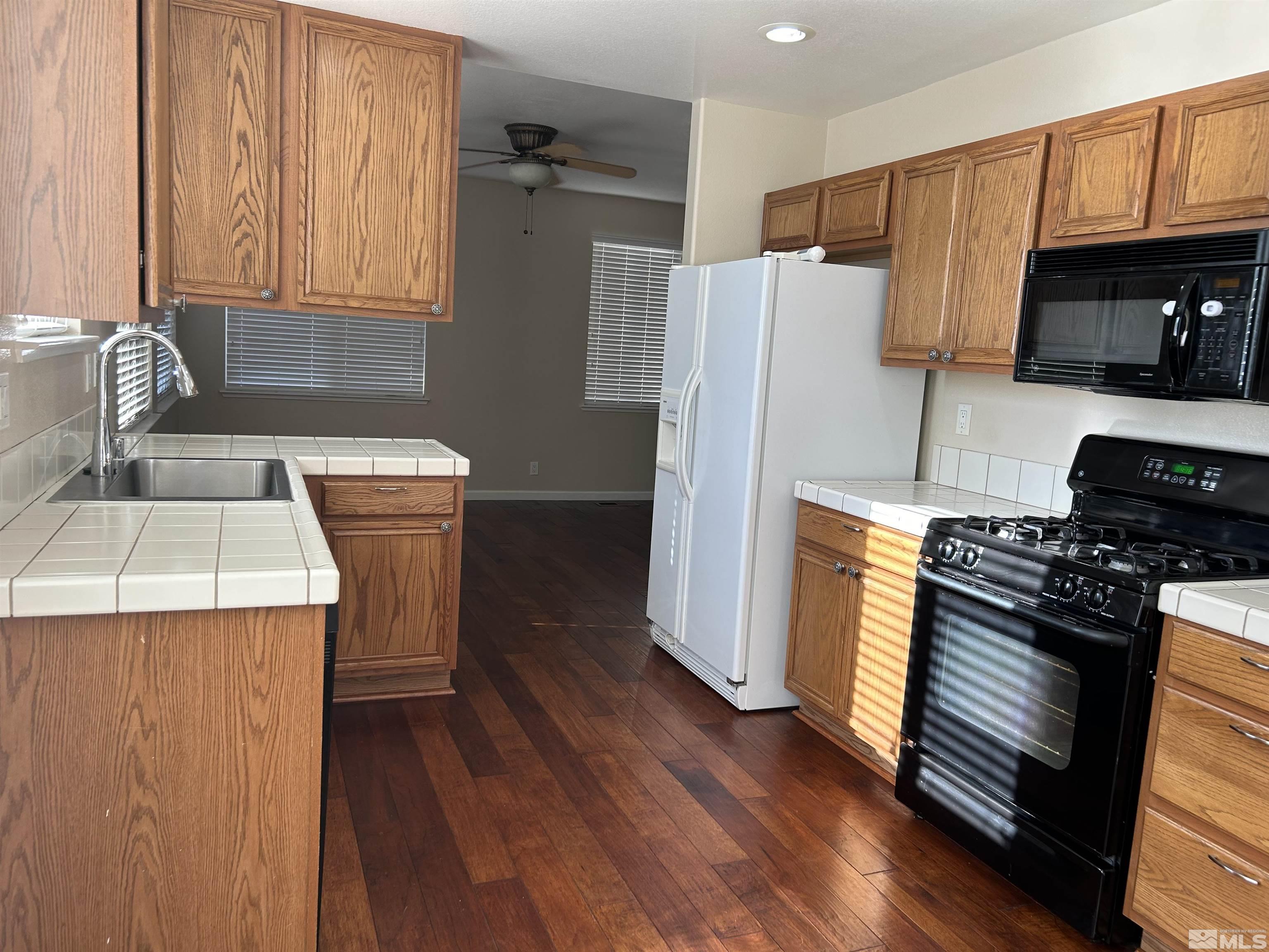 10047 Silver Star Drive Reno, NV 89521 - Photo 8 of 26 a kitchen with a refrigerator sink and stove
