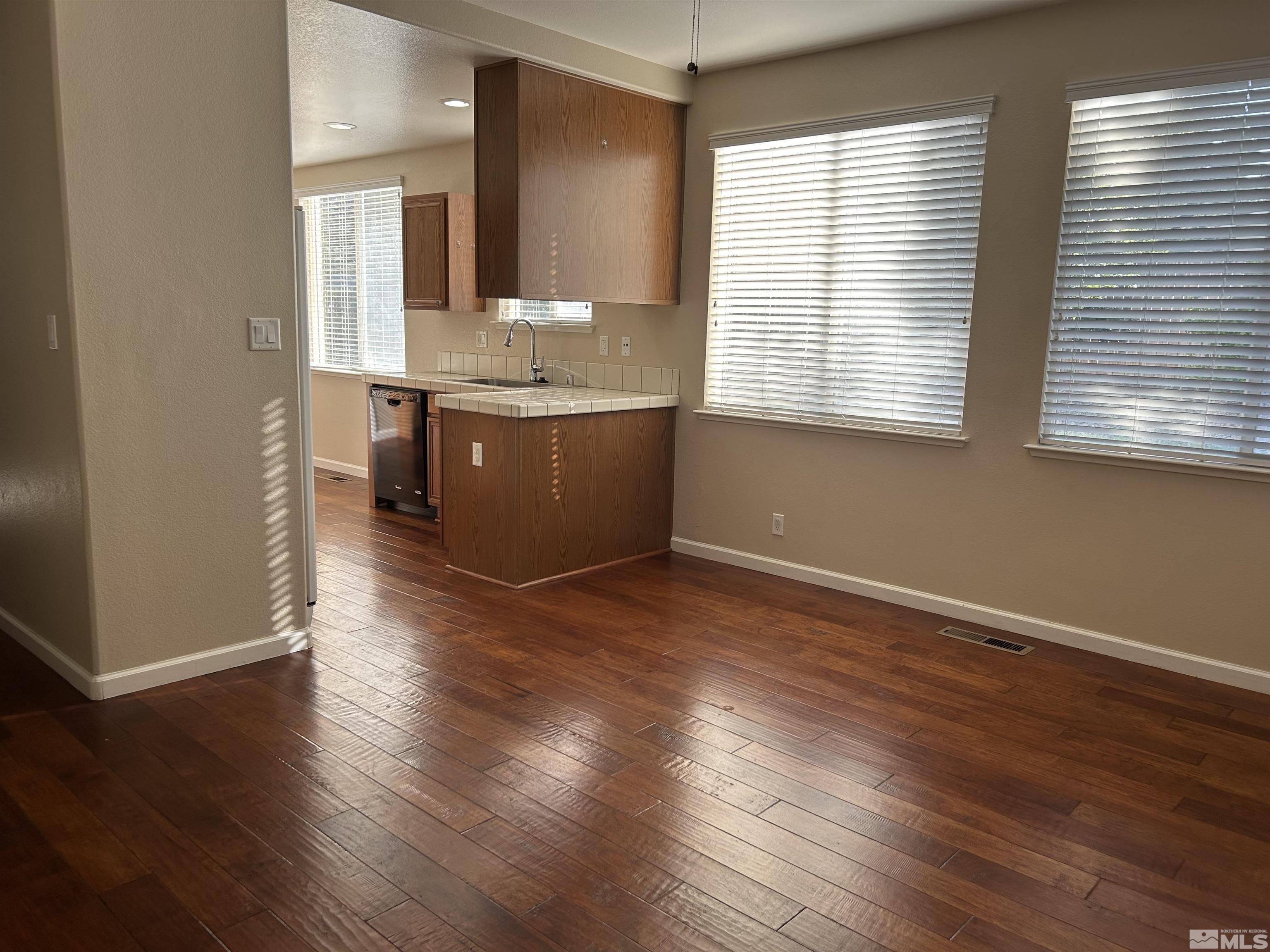10047 Silver Star Drive Reno, NV 89521 - Photo 9 of 26 a kitchen with wooden floors and sink