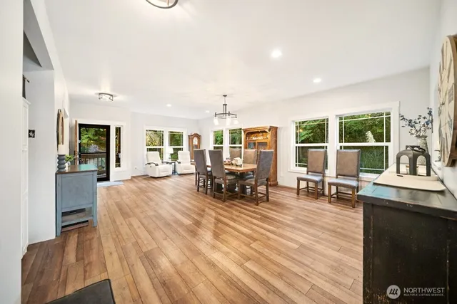 a living room with furniture and a dining table with kitchen view