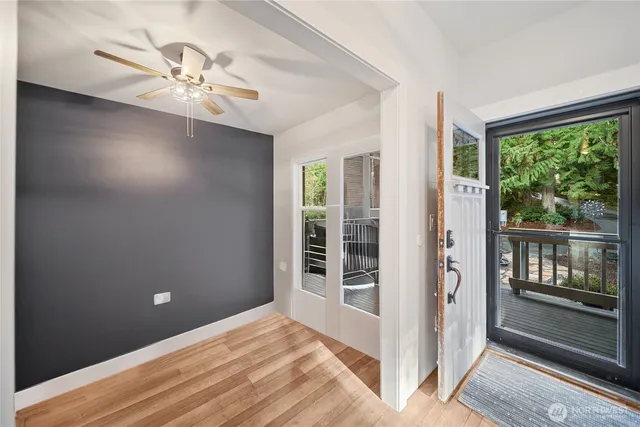 a living room with furniture flat screen tv and wooden floor