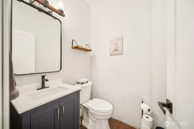 a bedroom with a bed and a wooden floor