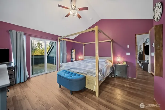 a living room with furniture a flat screen tv and a floor to ceiling window