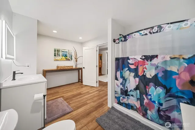 a room with furniture pool table flat screen tv and windows