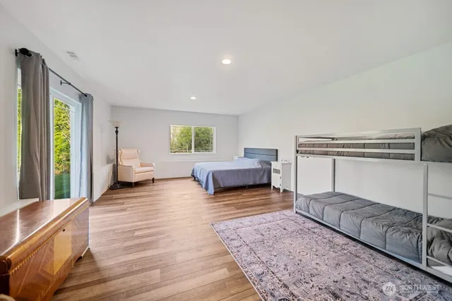 a view of a patio with table and chairs under an umbrella with wooden floor