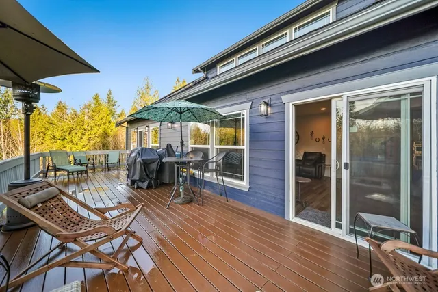 a view of a lush green forest with trees and some houses