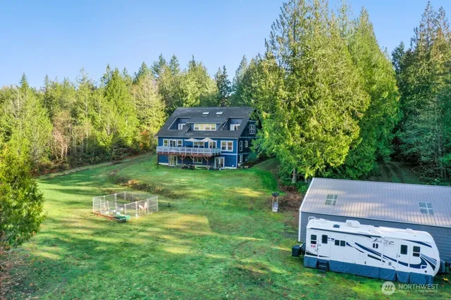 a aerial view of a house with a yard table and chairs