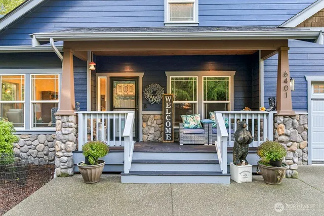 a kitchen with stainless steel appliances kitchen island granite countertop a table chairs sink and cabinets