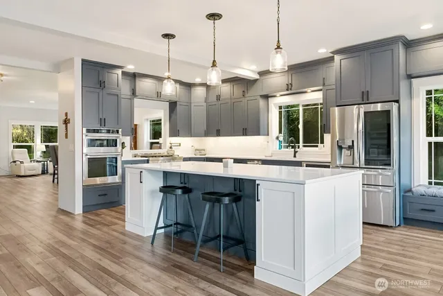 a kitchen with stainless steel appliances a refrigerator sink and stove