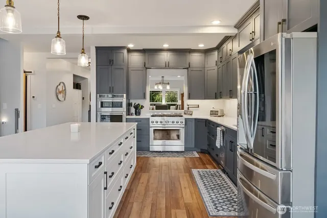 a kitchen with stainless steel appliances granite countertop a refrigerator and a sink