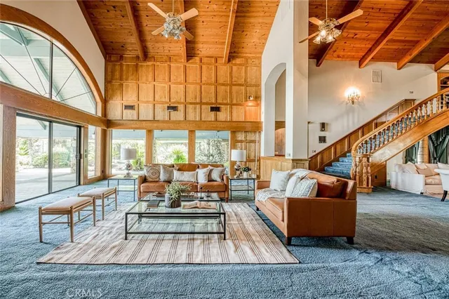 a living room with couches a coffee table and a fireplace