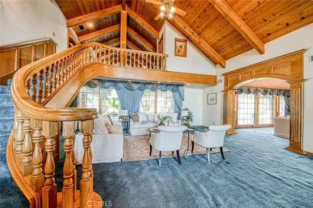a living room with furniture a fireplace and a floor to ceiling window