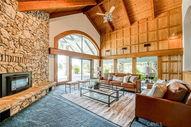 a dining room with furniture a rug and a large window