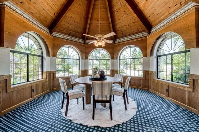 a dining room with furniture a chandelier and wooden floor
