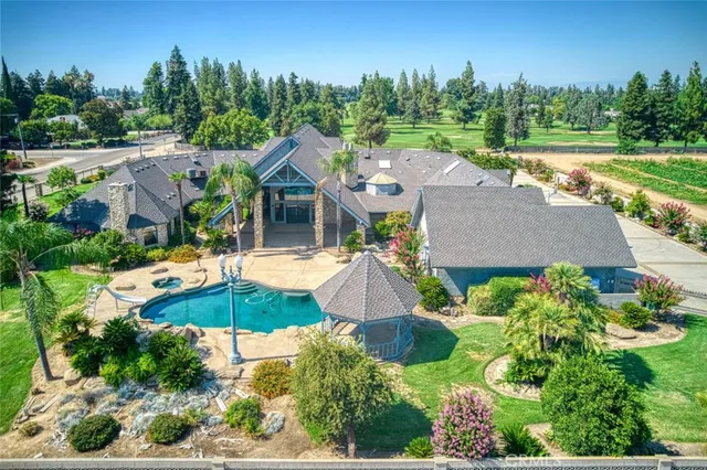 an aerial view of residential houses with outdoor space and lake view