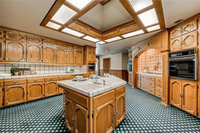 a kitchen with stainless steel appliances granite countertop a stove a sink dishwasher and cabinets with wooden floor