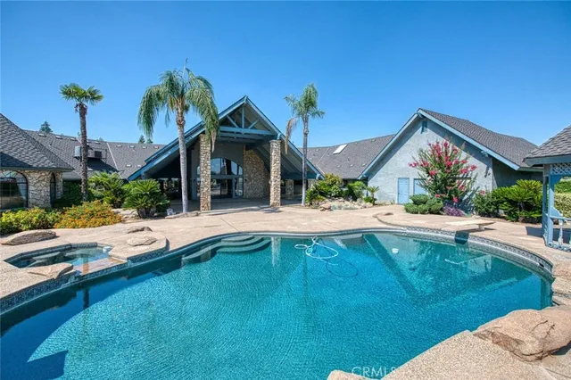 a view of a house with swimming pool and sitting area
