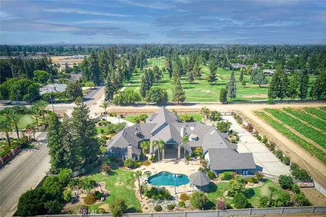 an aerial view of residential houses with outdoor space and street view
