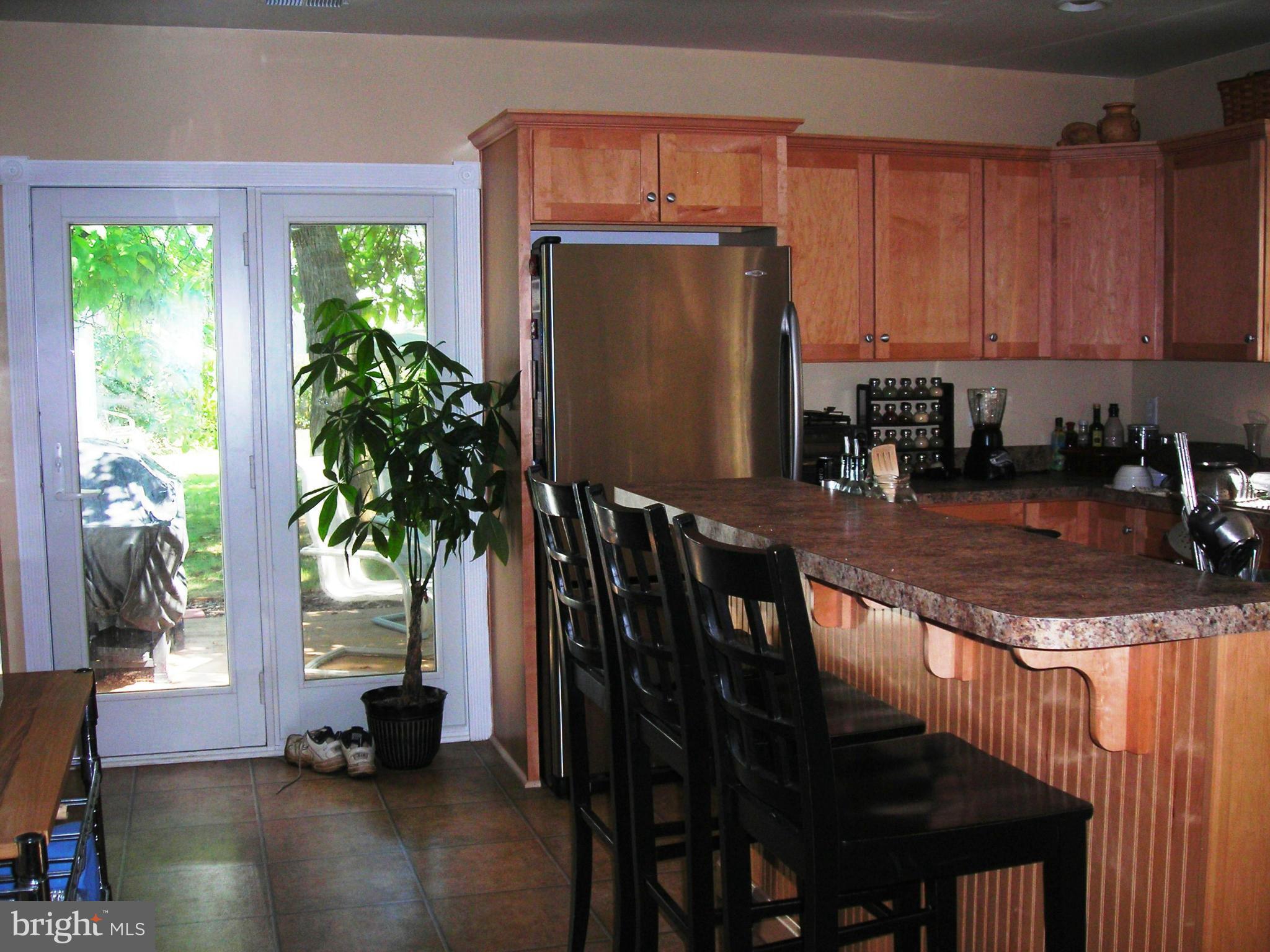 501 South Mildred Street Ranson, WV 25438 - Photo 11 of 29 a kitchen with stainless steel appliances granite countertop a stove a refrigerator and a dining table