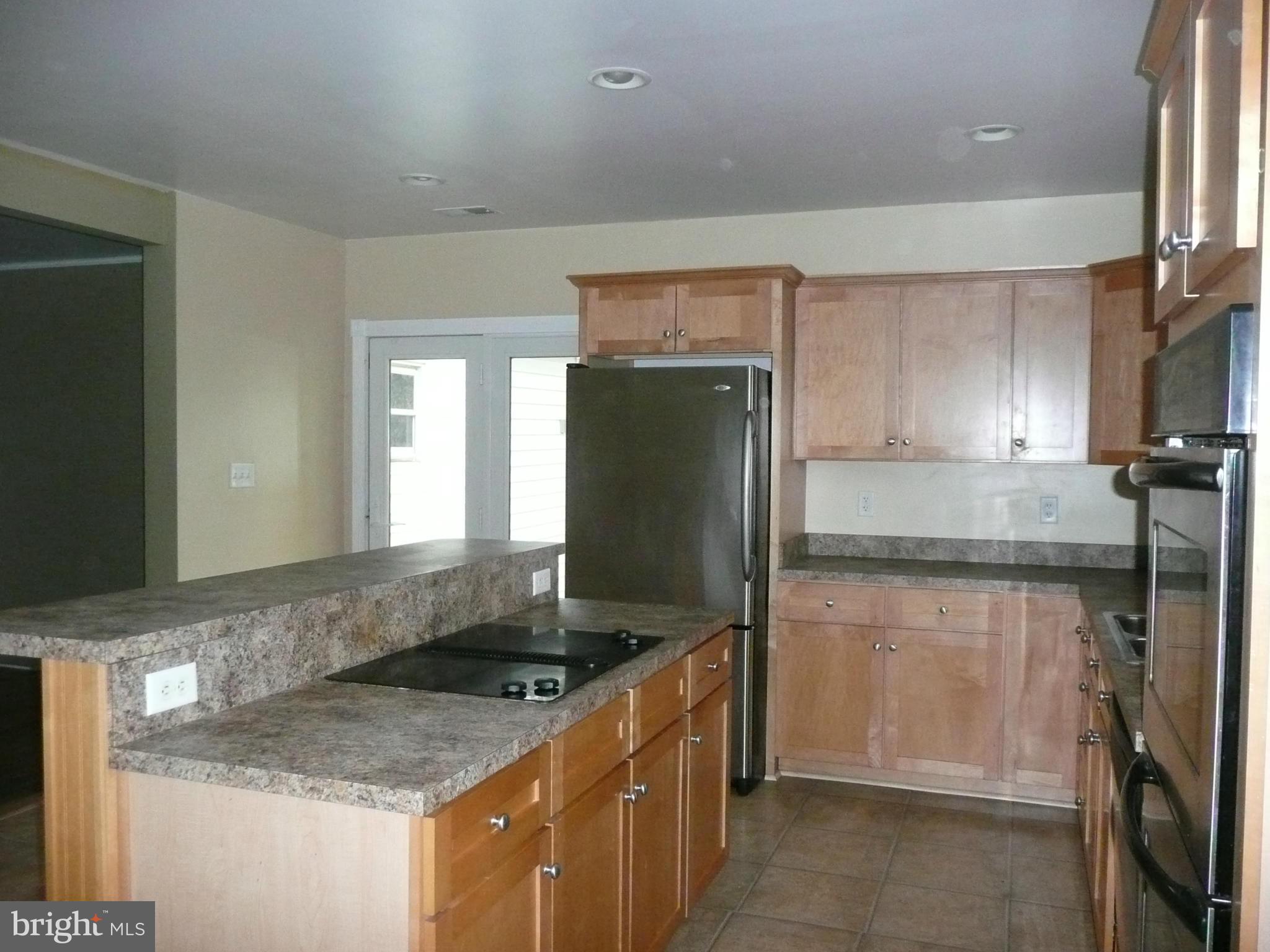 501 South Mildred Street Ranson, WV 25438 - Photo 12 of 29 a kitchen with stainless steel appliances granite countertop a sink stove and refrigerator