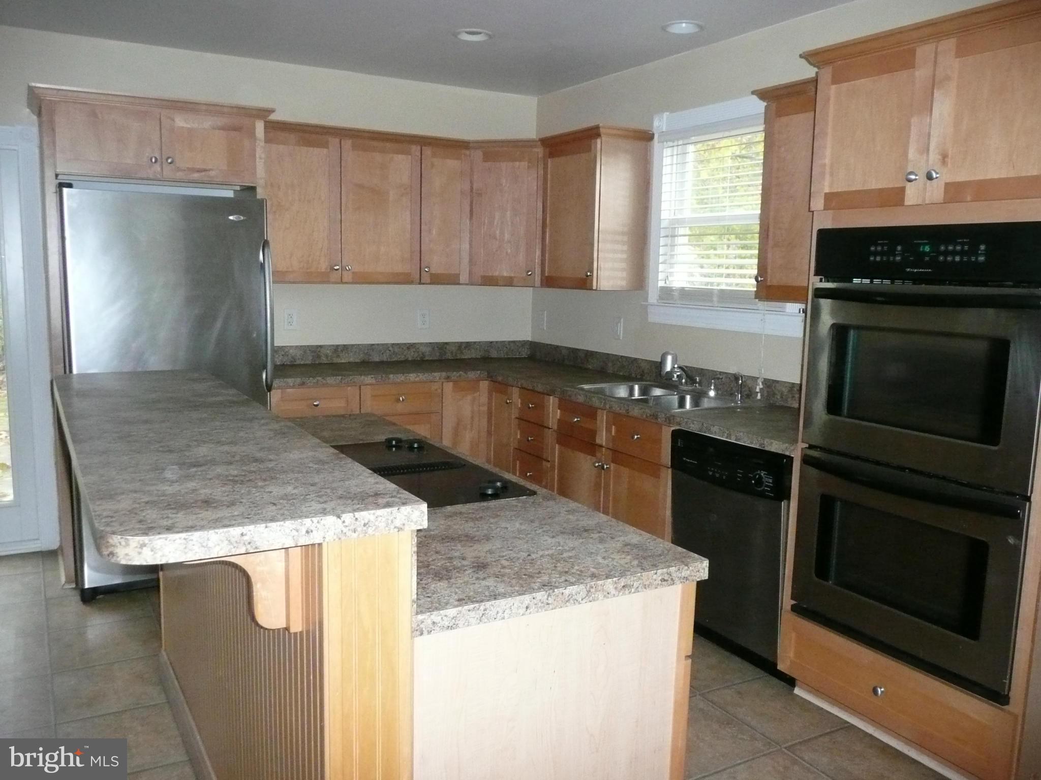 501 South Mildred Street Ranson, WV 25438 - Photo 14 of 29 a kitchen with granite countertop a sink a stove and oven