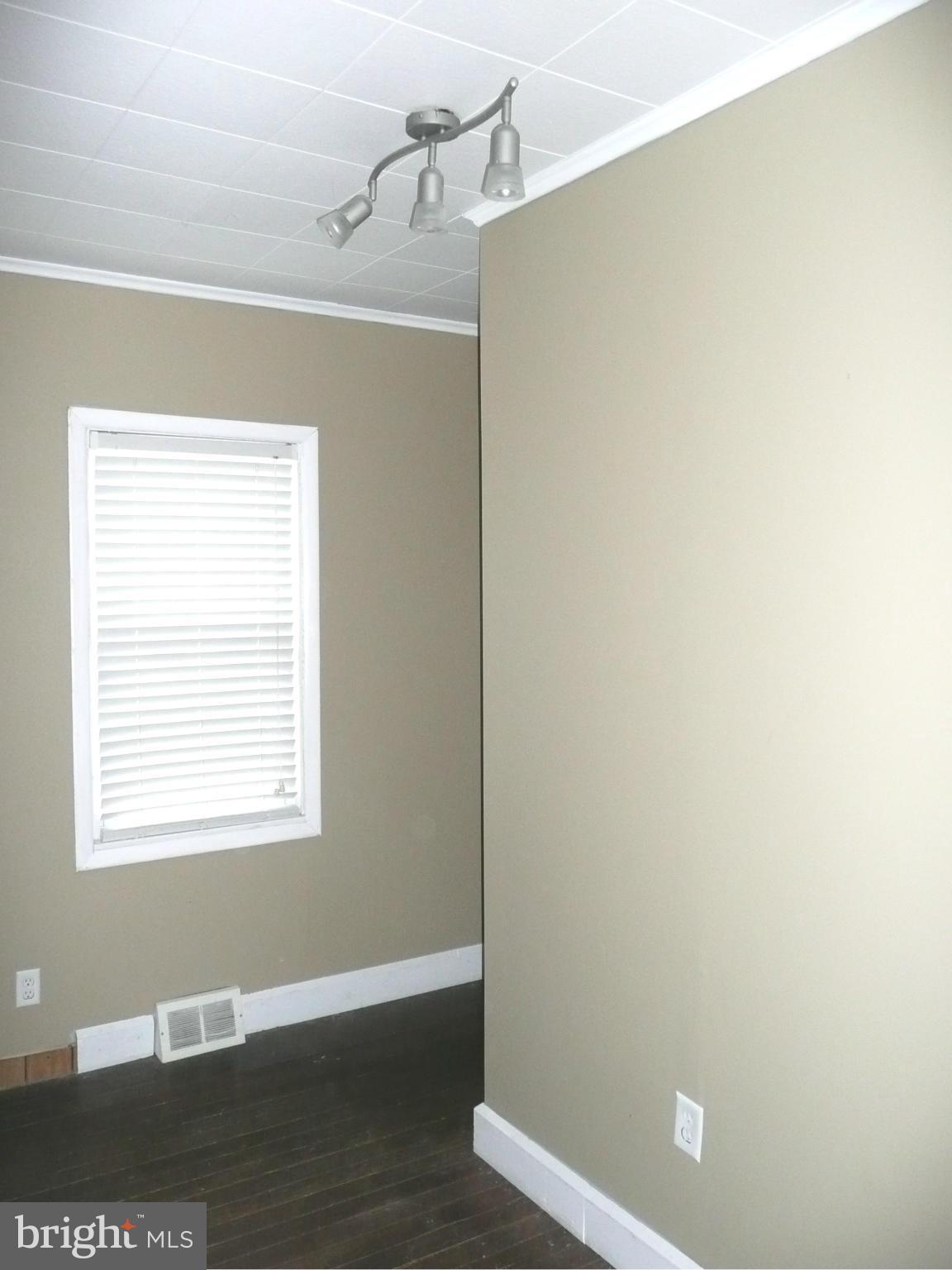 501 South Mildred Street Ranson, WV 25438 - Photo 4 of 29 a view of an empty room with wooden floor and a window
